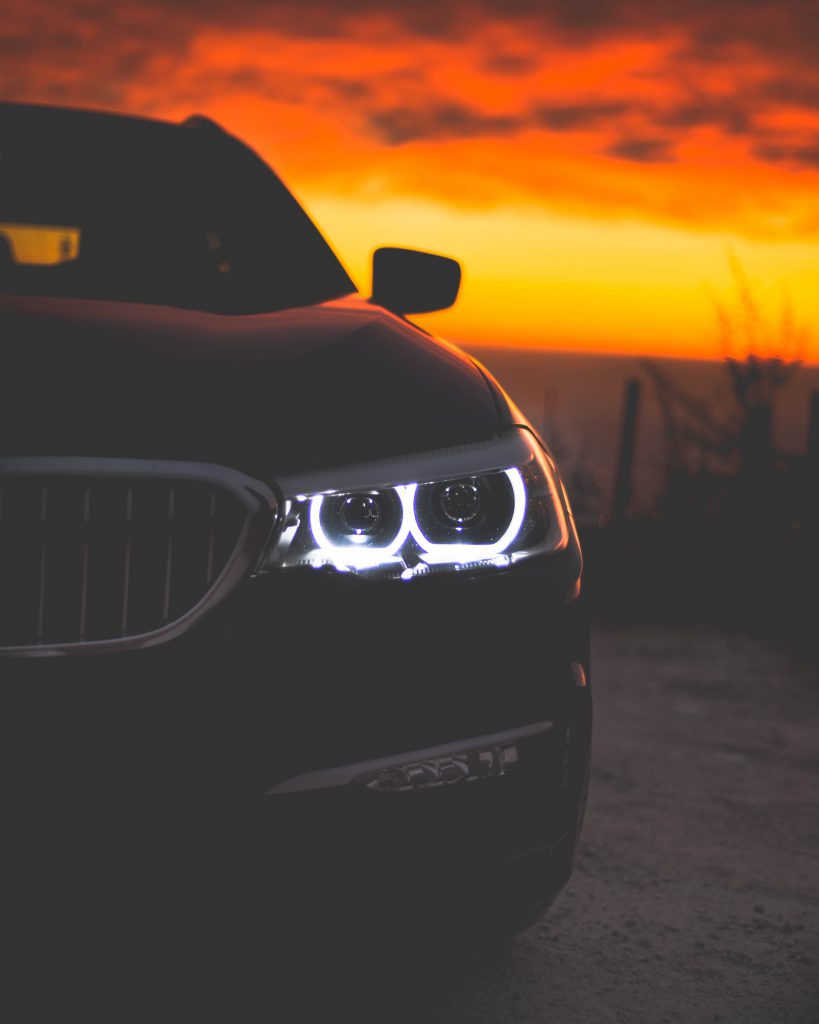 Black BMW 3 Series by a glowing sunset