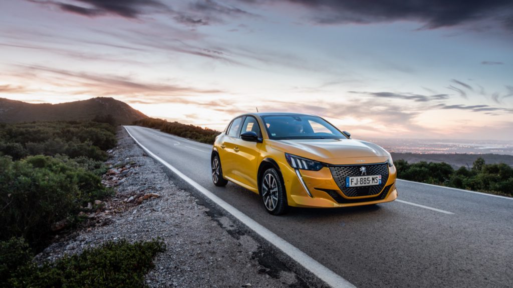 Yellow Peugeot 208 driving along the road