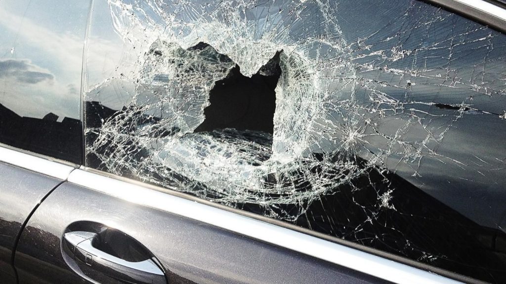 Smashed side window of a car, needing a glass replacement