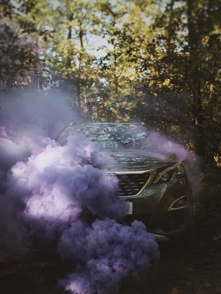 Purple smoke hiding a Peugeot 208 with a brand new windscreen replacement