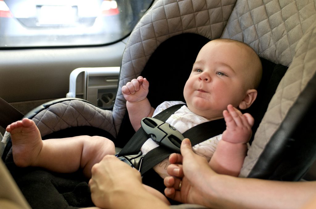 Infant buckled safely in car seat