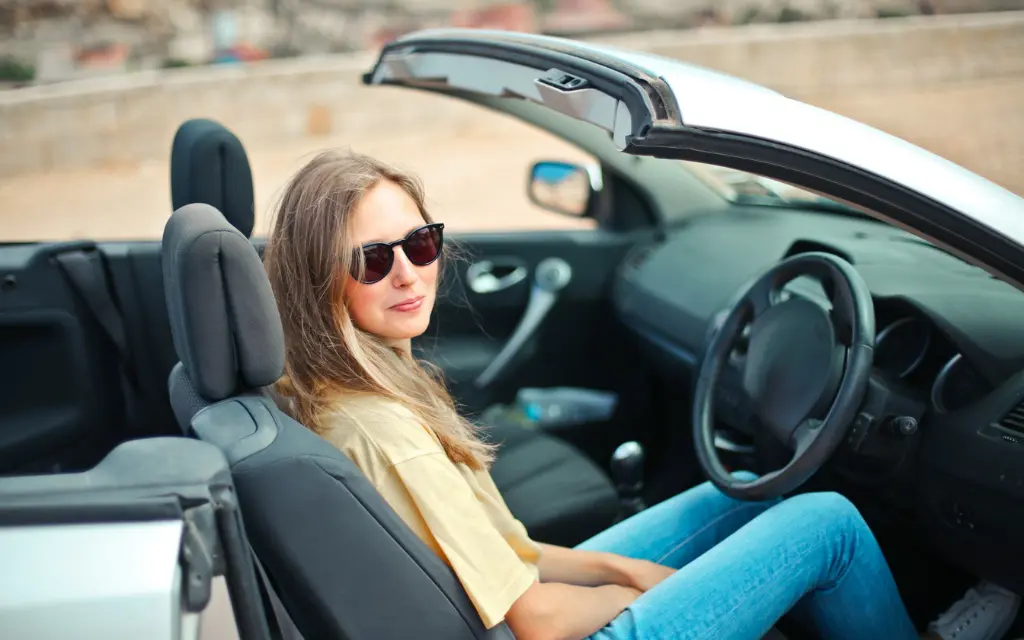 Driving a cabriolet car with sunglasses
